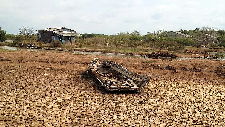 A broken boat on the bottom of a dried pond during drought in Mekong Delta