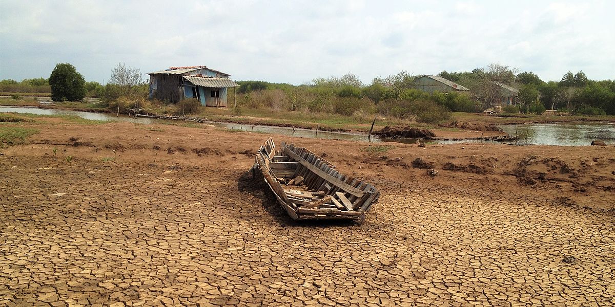A broken boat on the bottom of a dried pond during drought in Mekong Delta